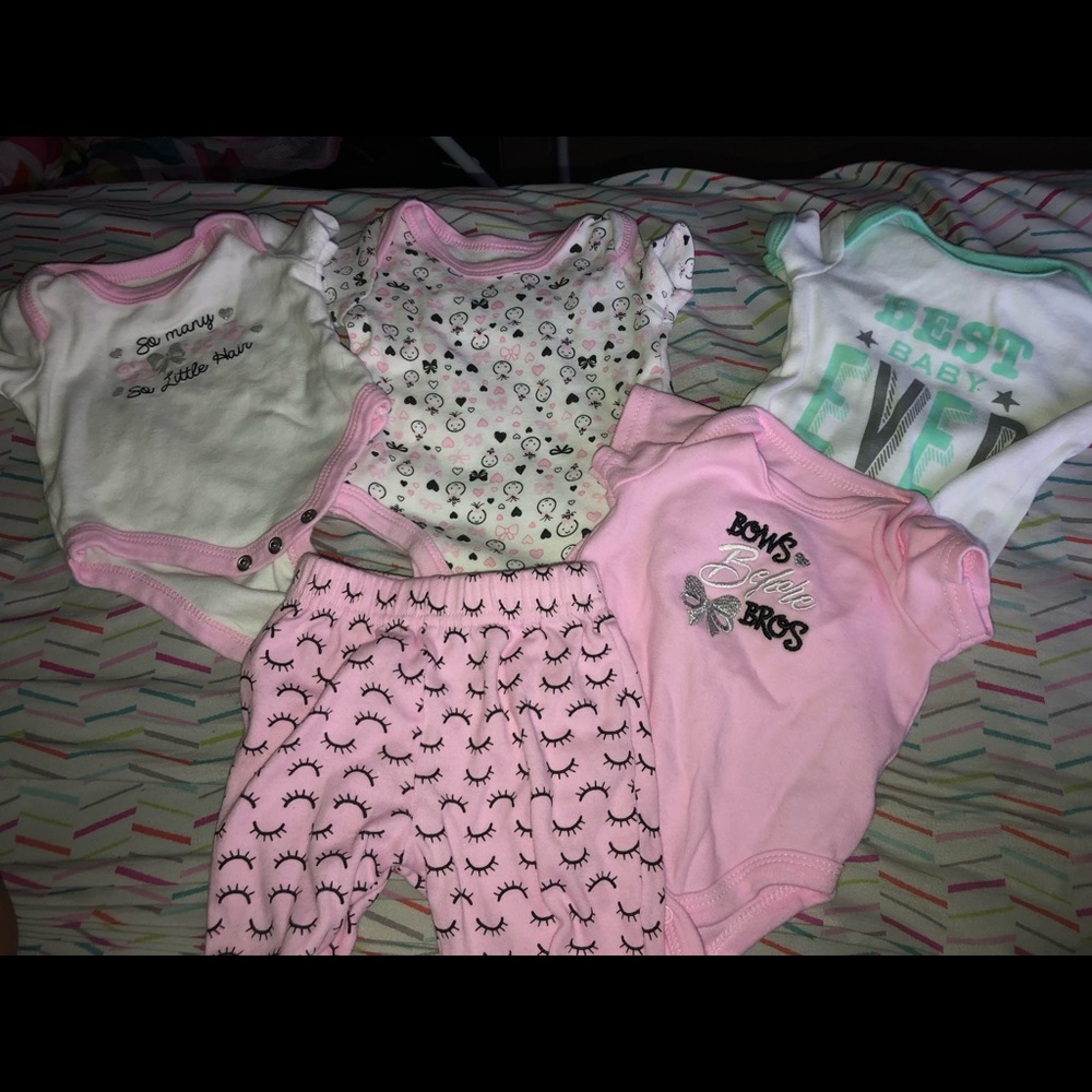 Four 0-3 months body suits with a pair of pants